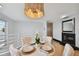 Bright dining room features a modern chandelier, fireplace and waterfront view from the window at 4950 Bayshore Blvd # 23, Tampa, FL 33611