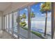Gorgeous waterfront view with manicured landscaping and palm trees from the floor to ceiling windows at 4950 Bayshore Blvd # 23, Tampa, FL 33611