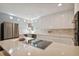 Bright kitchen boasts white cabinetry, stainless appliances, and a center island cooktop at 4950 Bayshore Blvd # 23, Tampa, FL 33611
