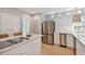 Modern kitchen with white cabinets, stainless steel appliances, and center island cooktop at 4950 Bayshore Blvd # 23, Tampa, FL 33611
