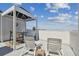 Relaxing rooftop patio with lounge chairs and dining area, offering stunning city views at 4950 Bayshore Blvd # 23, Tampa, FL 33611