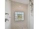Shower featuring a glass block window, tile accents, and bronze fixtures at 4950 Bayshore Blvd # 23, Tampa, FL 33611