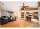 Living room with fireplace, wood floors, and kitchen access at 7022 Arbor View Ln, New Port Richey, FL 34653