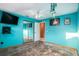 Bedroom with teal walls, wood floors, and mirrored closet doors at 7022 Arbor View Ln, New Port Richey, FL 34653