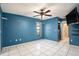 Spacious bedroom with blue walls and tile floors at 7022 Arbor View Ln, New Port Richey, FL 34653