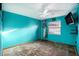 Bright bedroom with teal walls and wood floors at 7022 Arbor View Ln, New Port Richey, FL 34653