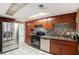 Modern kitchen with stainless steel appliances and wood cabinets at 7022 Arbor View Ln, New Port Richey, FL 34653