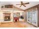 Living room with fireplace, kitchen view, and patio doors at 7022 Arbor View Ln, New Port Richey, FL 34653