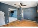 Bedroom with wood floors, a closet, and view into another room at 7022 Arbor View Ln, New Port Richey, FL 34653