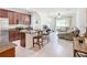 Open kitchen with island, stainless steel appliances, and adjacent living room at 11650 Cambium Crown Dr, Riverview, FL 33569