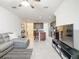 Open concept living room and kitchen with gray sectional sofa at 11650 Cambium Crown Dr, Riverview, FL 33569