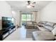 Spacious living room with a large sectional sofa and a flat-screen TV at 11650 Cambium Crown Dr, Riverview, FL 33569