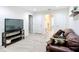 Spacious bonus room with large TV, comfortable seating, and access to other rooms at 11650 Cambium Crown Dr, Riverview, FL 33569