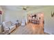 Relaxing living room with hardwood floors, comfortable seating, and access to other rooms at 736 Mccallister Ave, Sun City Center, FL 33573