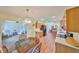 Galley kitchen with wood cabinets, updated appliances, and adjacent dining area at 736 Mccallister Ave, Sun City Center, FL 33573