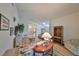 Bright living room with hardwood floors, featuring a comfy sofa and charming decor at 736 Mccallister Ave, Sun City Center, FL 33573