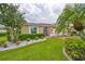 Landscaped exterior of tan one-story home at 736 Mccallister Ave, Sun City Center, FL 33573