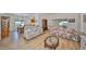 Open living space with hardwood floors, ample seating, and views into dining area at 736 Mccallister Ave, Sun City Center, FL 33573