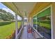 Relaxing screened porch with seating area, overlooking grassy backyard at 736 Mccallister Ave, Sun City Center, FL 33573
