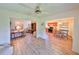 Open living room with kitchen view, hardwood floors, and ceiling fan at 736 Mccallister Ave, Sun City Center, FL 33573