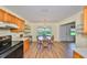 Eat-in kitchen with wood cabinets, breakfast nook, and access to backyard at 736 Mccallister Ave, Sun City Center, FL 33573