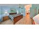 Main bedroom with light blue walls, hardwood floors, and ensuite bathroom access at 736 Mccallister Ave, Sun City Center, FL 33573