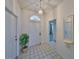 Bright entryway with white door and tiled floor, view to living room at 736 Mccallister Ave, Sun City Center, FL 33573