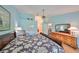 Main bedroom features light blue walls, hardwood floors, and a large bed at 736 Mccallister Ave, Sun City Center, FL 33573