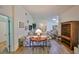 Living room boasts hardwood floors, floral sofa, and wooden shelving unit at 736 Mccallister Ave, Sun City Center, FL 33573