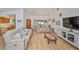 Living Room with light wood floors, comfy sofas, and large TV at 736 Mccallister Ave, Sun City Center, FL 33573
