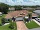 Aerial view showcasing the house's layout, roof, and surrounding landscape at 736 Mccallister Ave, Sun City Center, FL 33573