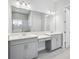 Double vanity bathroom with a large mirror and a walk-in shower at 13114 Homestead Ln, Parrish, FL 34219