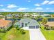 Aerial view of a beautiful waterfront property with lush landscaping and neighborhood canal access at 5217 Forbes Ter, Port Charlotte, FL 33981