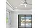 Bright bedroom featuring a ceiling fan, tray ceiling, recessed lights, and sliding glass doors to the lanai at 5217 Forbes Ter, Port Charlotte, FL 33981