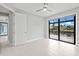 Bright bedroom with sliding glass doors offering waterfront views and access to the screened lanai at 5217 Forbes Ter, Port Charlotte, FL 33981
