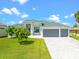 Modern house with three-car garage and paved driveway at 5217 Forbes Ter, Port Charlotte, FL 33981