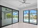 Gathering room with sliding glass doors opening to a pool and canal at 5217 Forbes Ter, Port Charlotte, FL 33981