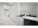 A laundry room with washer and dryer and shelving at 5217 Forbes Ter, Port Charlotte, FL 33981