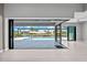 Living room featuring expansive sliding glass doors which create a seamless transition to the outdoor pool and canal at 5217 Forbes Ter, Port Charlotte, FL 33981
