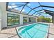 Resort-style pool with covered patio and canal views at 5217 Forbes Ter, Port Charlotte, FL 33981