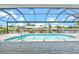 A screened-in pool offers a refreshing waterfront view and a tranquil outdoor living space at 5217 Forbes Ter, Port Charlotte, FL 33981