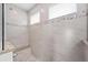 The shower has stone tile with a built-in bench and decorative shower tile at 5217 Forbes Ter, Port Charlotte, FL 33981
