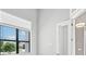 Bright room featuring a window with views of exterior landscape and a door with white trim at 5217 Forbes Ter, Port Charlotte, FL 33981