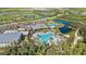 Aerial view of resort-style pool, clubhouse, and expansive green spaces at 9276 Starry Night Ave, Sarasota, FL 34241