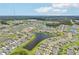 Aerial view of community with lake and homes at 12818 Boggy Creek Dr, Riverview, FL 33579