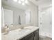 Modern bathroom with a quartz countertop, dark brown vanity, and a shower at 12818 Boggy Creek Dr, Riverview, FL 33579