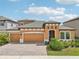 Orange two-story house with three-car garage at 12818 Boggy Creek Dr, Riverview, FL 33579
