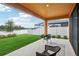 Covered patio overlooking a lake, with wicker chairs and a patterned rug at 12818 Boggy Creek Dr, Riverview, FL 33579