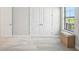 Well-lit bedroom featuring neutral walls, carpet flooring, and double door closet at 12818 Boggy Creek Dr, Riverview, FL 33579