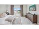 Bedroom with a king-size bed, large windows with lake view, and a dresser at 12818 Boggy Creek Dr, Riverview, FL 33579